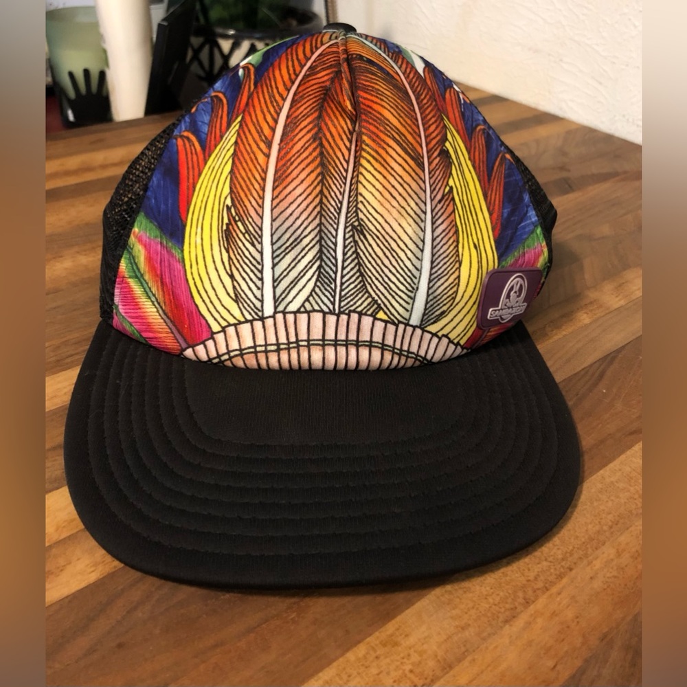 Warrior up multi colored feather design trucker hat.